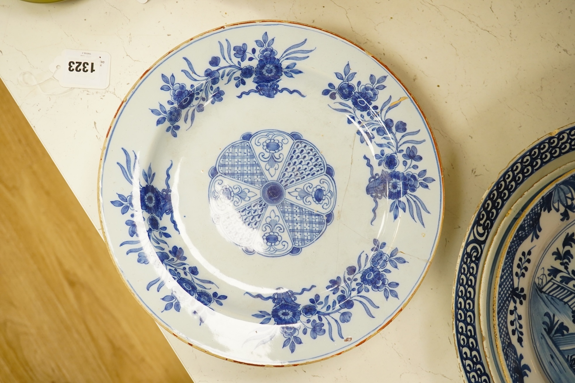 Five 18th century Delft dishes, largest 36.5cm diameter. Condition - poor to fair